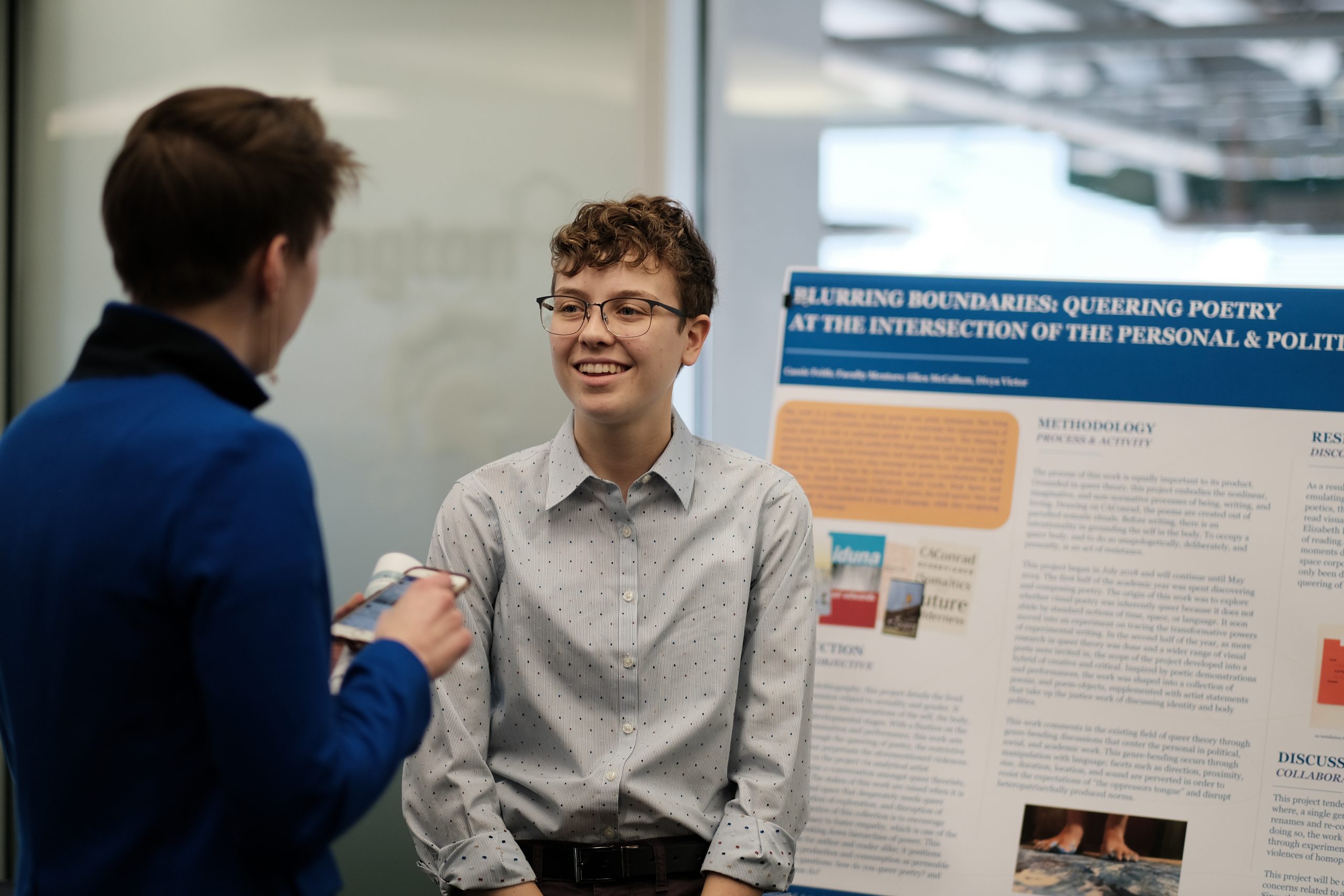 Student poster presenting at an event