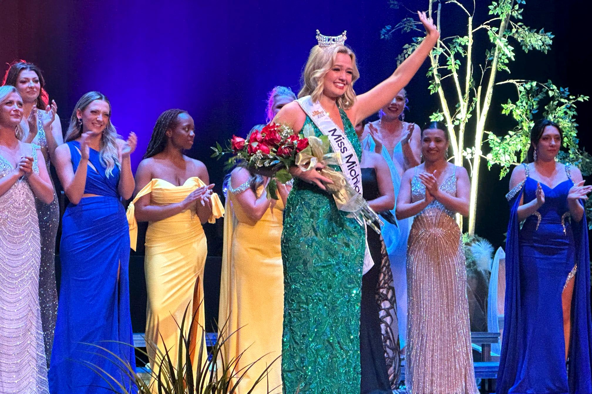 Maya Schuhknecht winning Miss Michigan, wearing green dress with sash and crown.