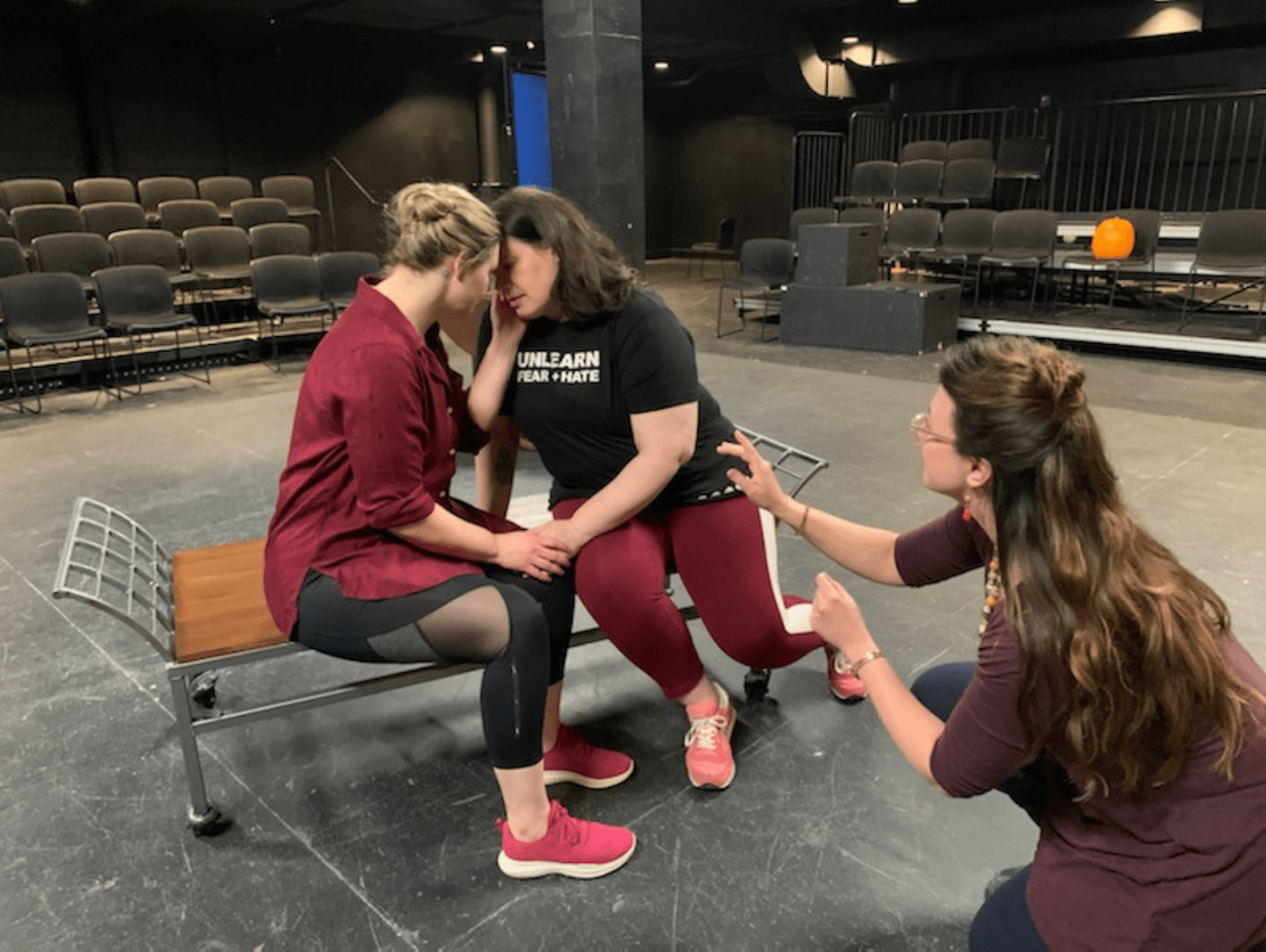 Alexis Black directs two women in a black box theatre through an intimate scene