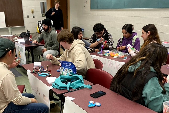Students create art at long tables inside MSU residence halls