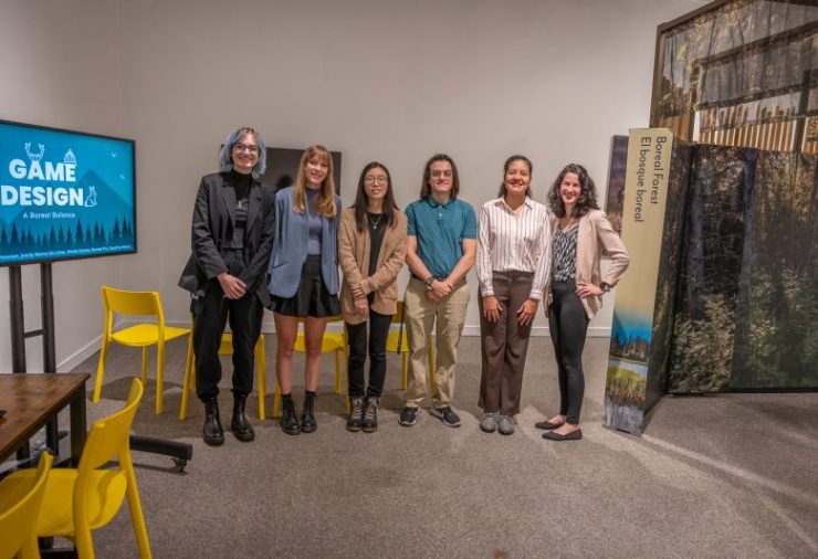 Five MSU students and MSU Museum staffer Caroline White pose in front of the exhibition 
