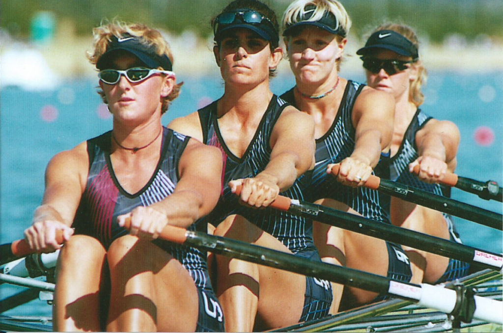Kelly Salchow MacArthur rowing with three other teammates.
