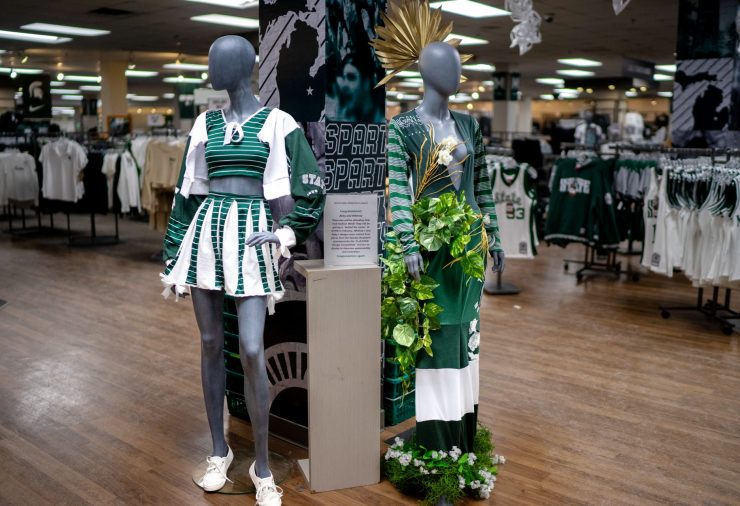 Mannequins wear two green and white designs, on display in the Spartan Bookstore