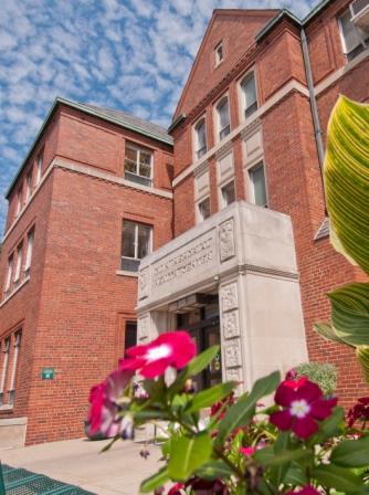 The entrance to Olin Health Center with flowers in front of it