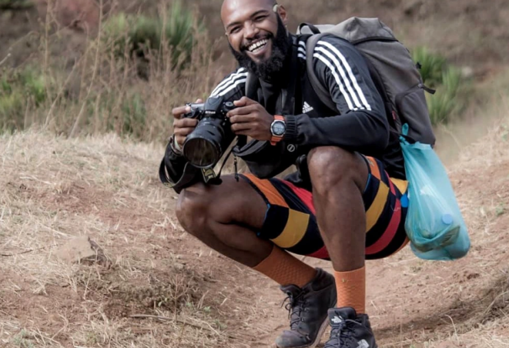 Vadu Rodrigues holding camera.