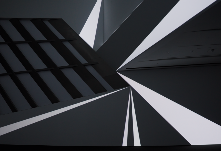 The inside of the museum walls is lit with various triangles of light.