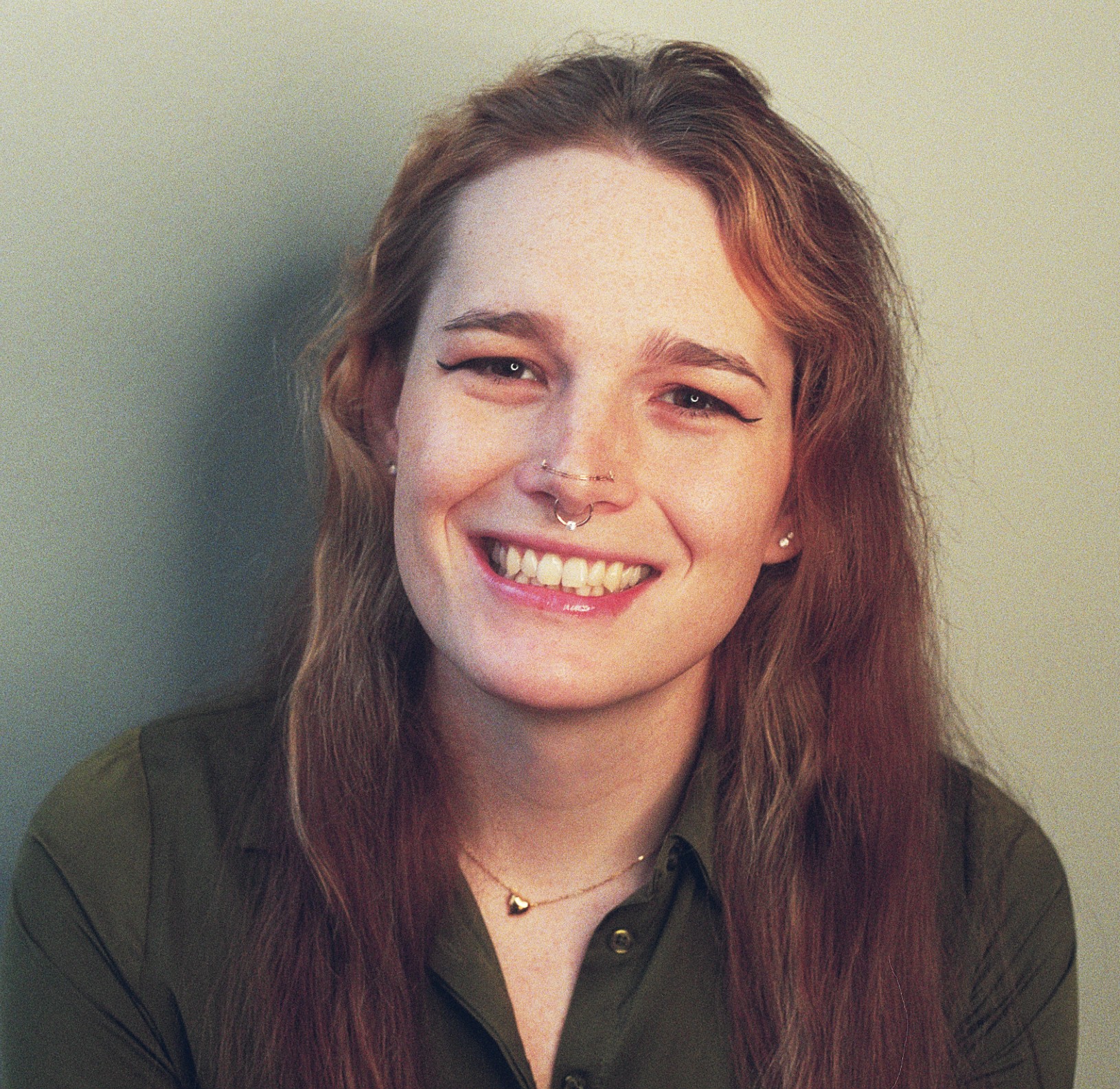 A portrait of Lorelei d’Andriole smiling against a light grey background.