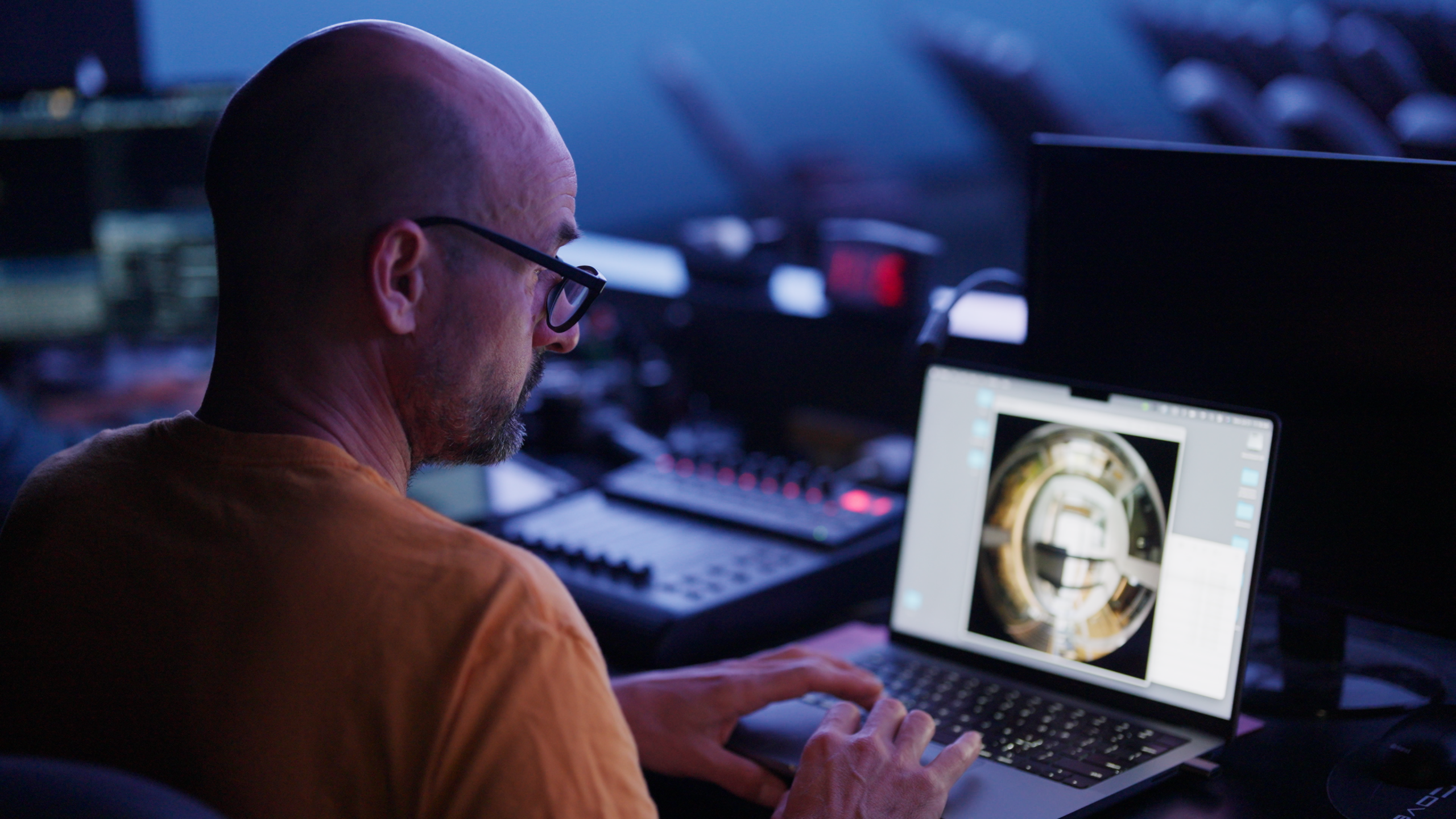 Artist Jan Tichy working on a laptop in planetarium.