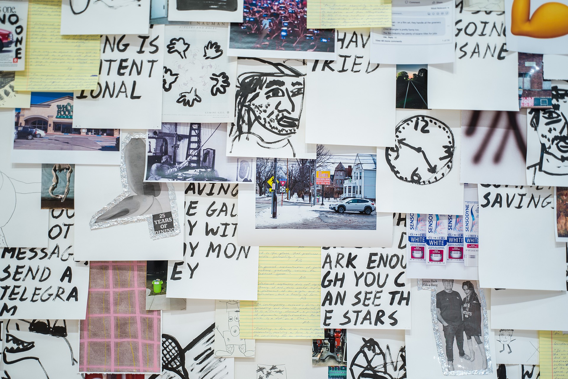 A collage of overlapping photos, sketches, and handwritten notes covers a wall. Elements include doodles, a clock, urban scenes, and sporadic text, conveying a chaotic, creative energy.