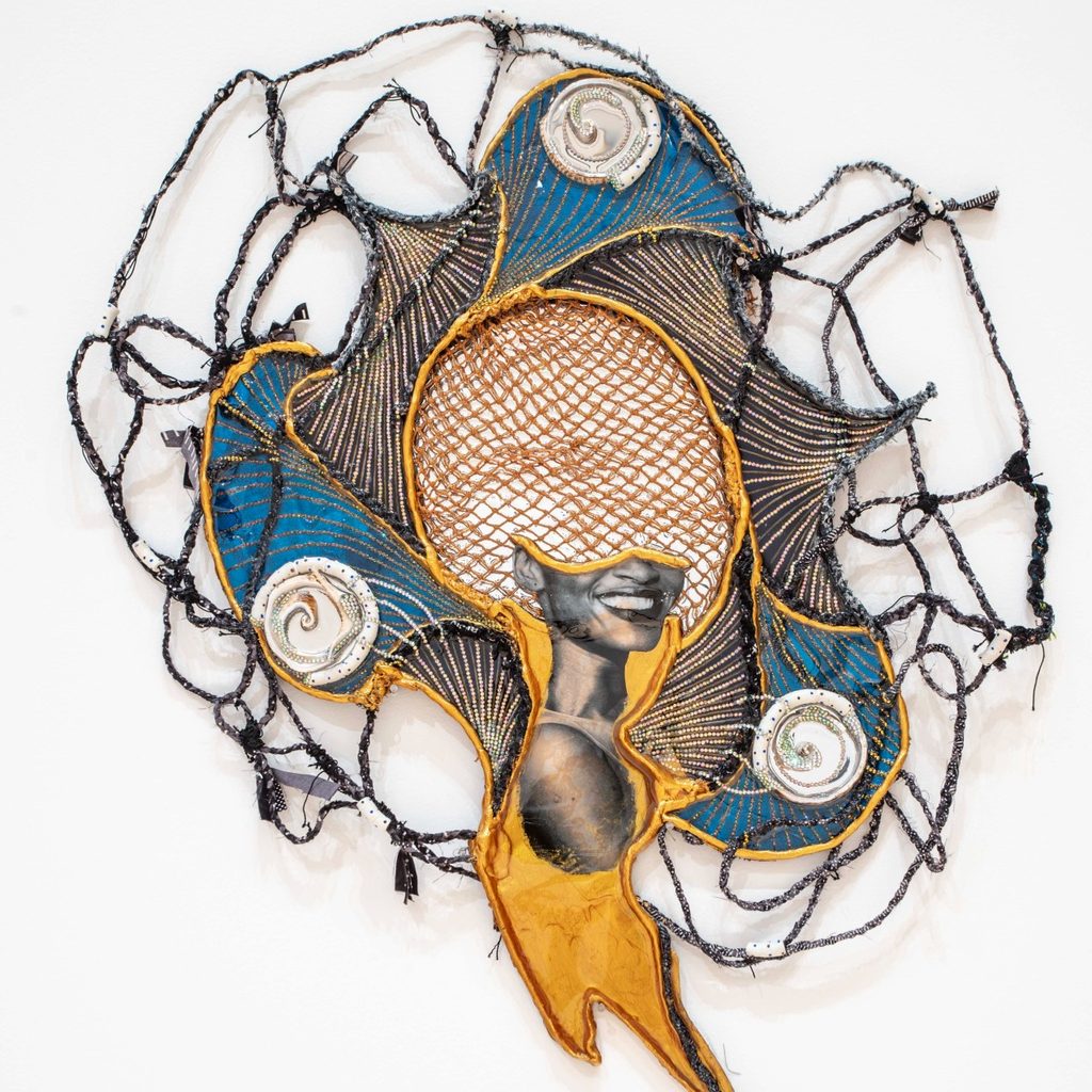 Abstract mixed-media artwork with a vivid blue and gold spiral design. Central mesh pattern reveals a smiling face, surrounded by dynamic textures.